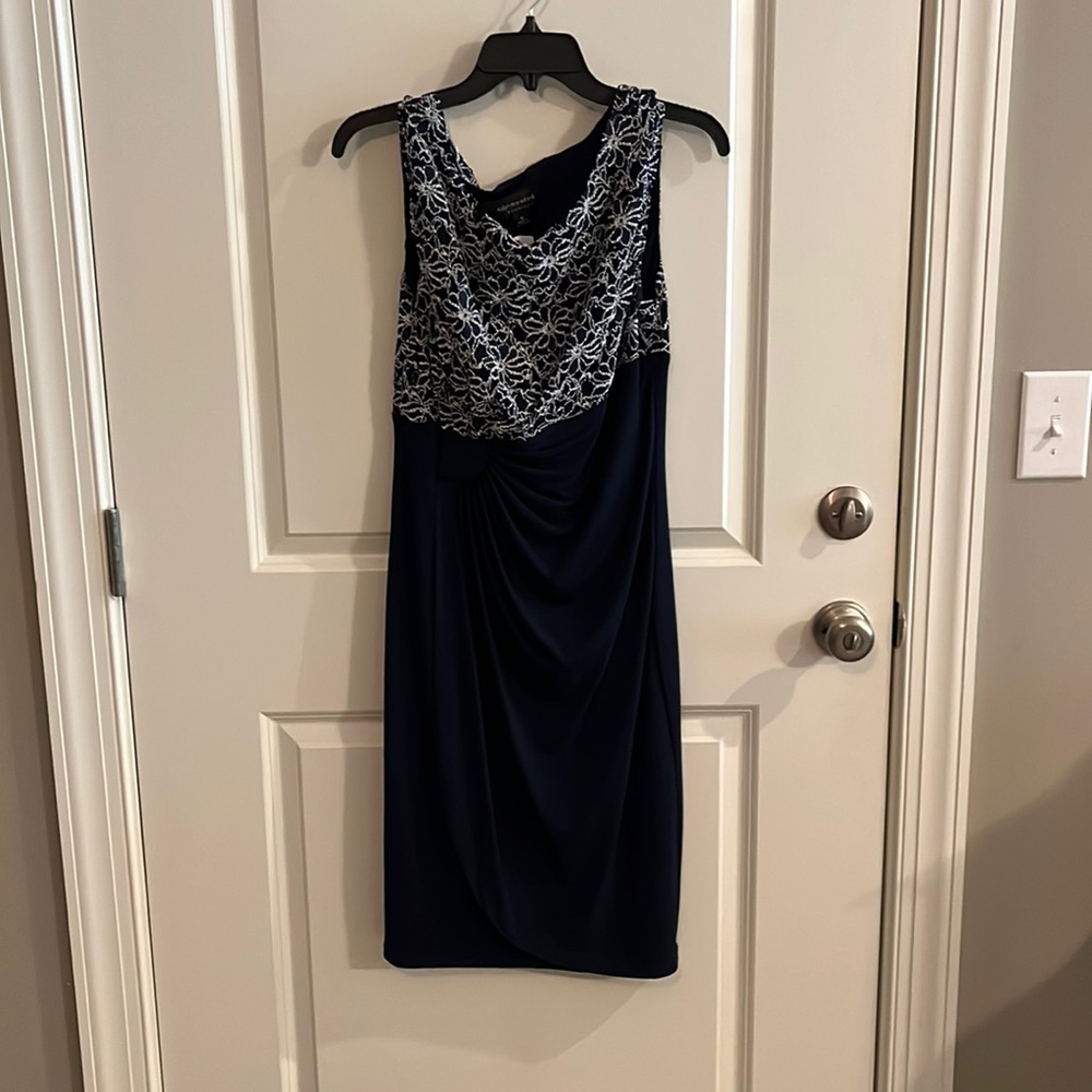 Semi formal dress navy with white design and a little sparkle. Size 10.